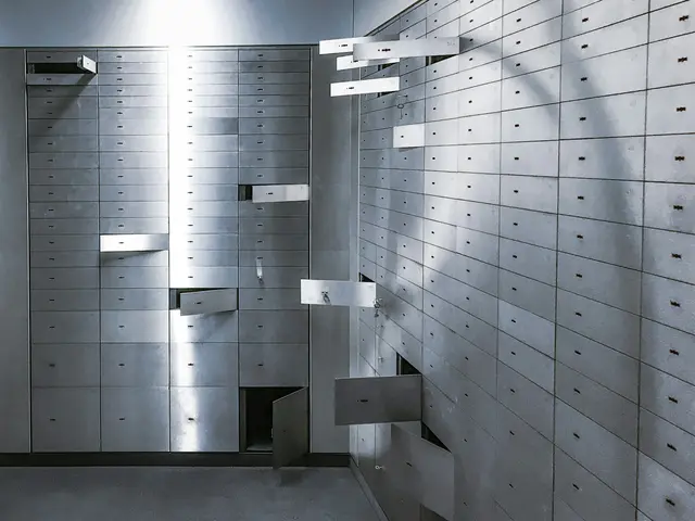 Rows of steel safe deposit boxes in a vault room